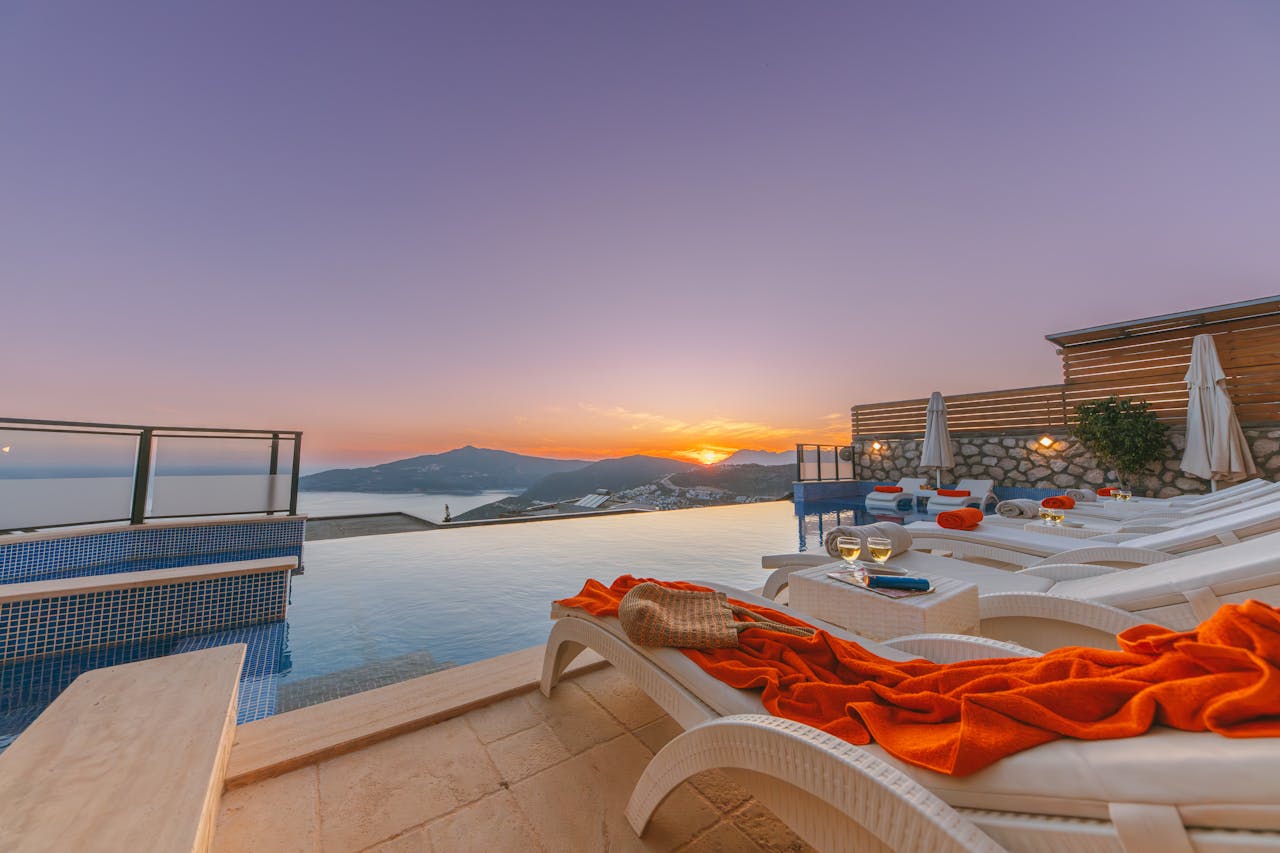 Luxury resort infinity pool at golden hour sunset