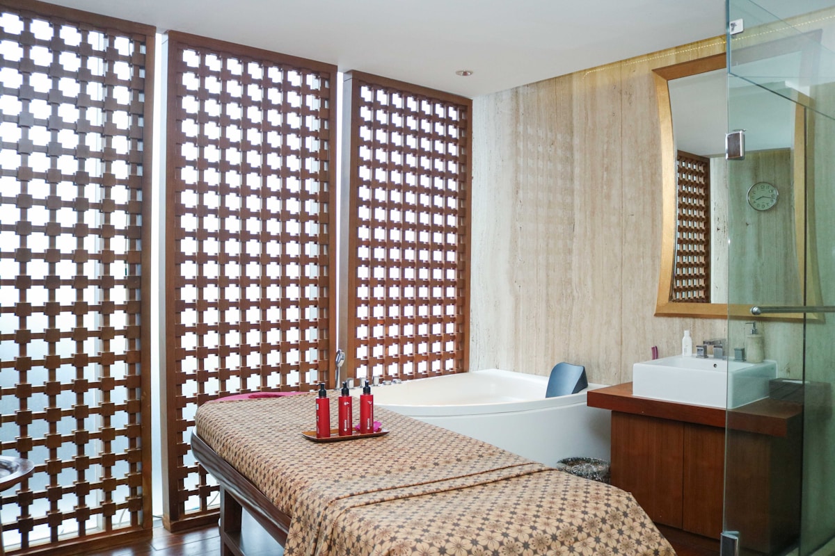 Luxury hotel spa treatment room with a guest receiving wellness services