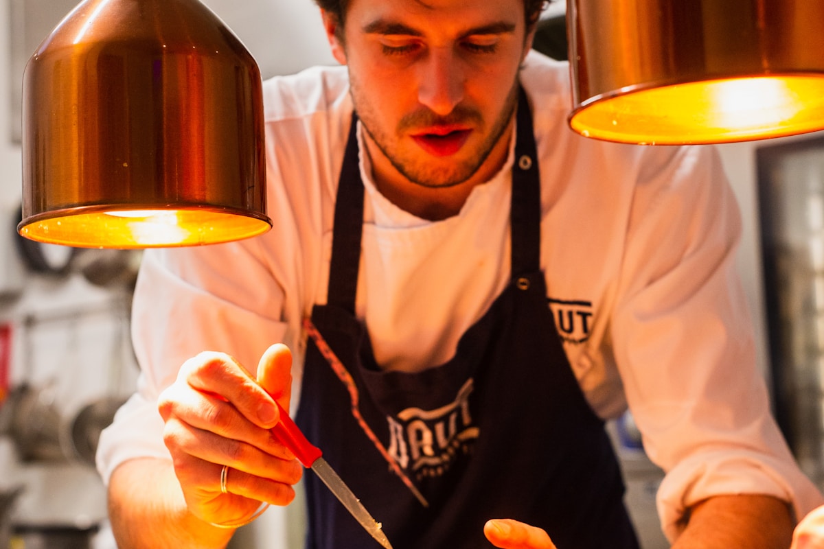 Hotel back-of-house kitchen team at work — where 15-25% of purchased food is lost before it reaches a guest
