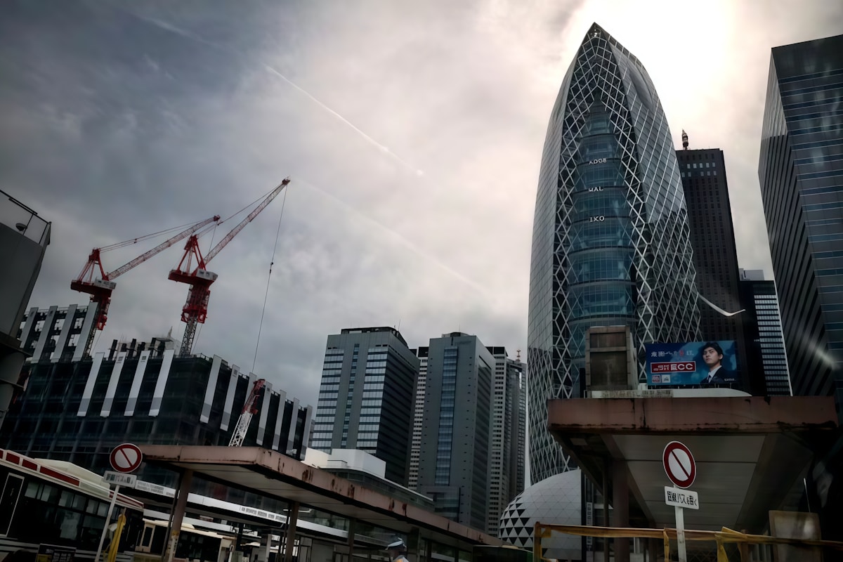 Modern hotel construction site with cranes, scaffolding, and luxury hotel architecture under development