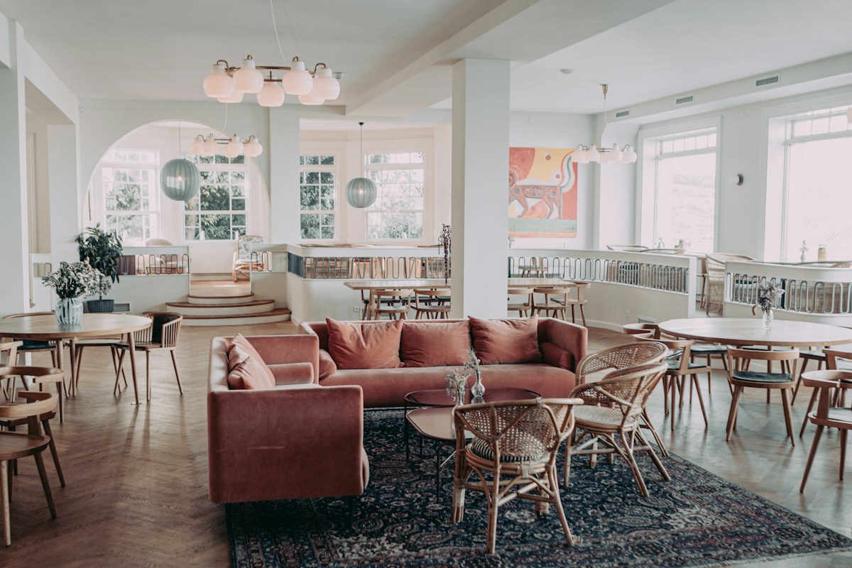 A stylish hotel lounge with comfortable seating and tables, the kind of space where corporate and group business gets courted