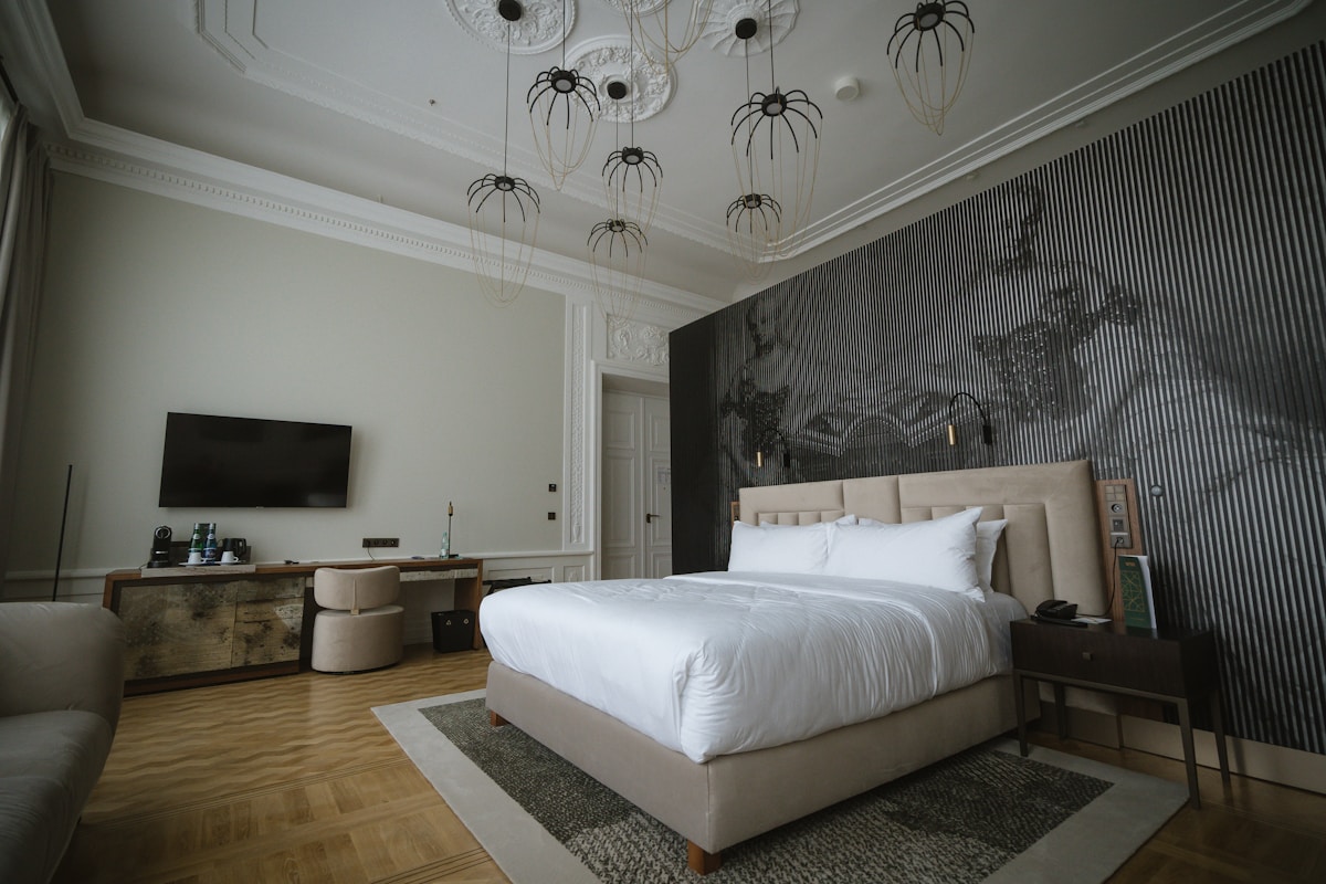 An upscale hotel guest room with a made bed, seating, and casegoods — the physical object that every brand standard audit ultimately scores