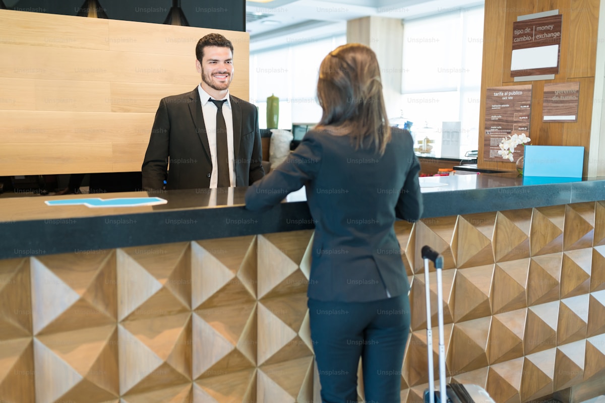A returning guest greeted personally at a luxury hotel reception — the moment loyalty is earned