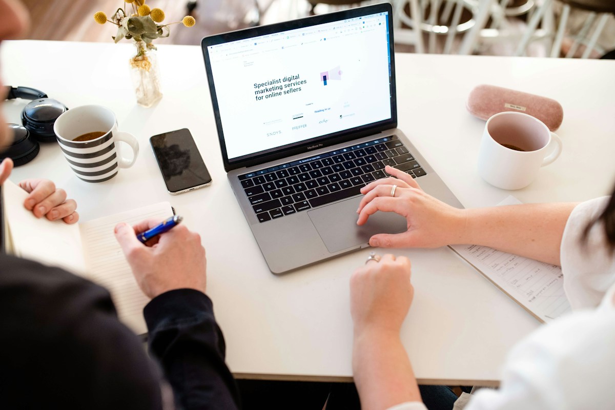 A marketer working on a laptop, allocating paid-search budget across channels